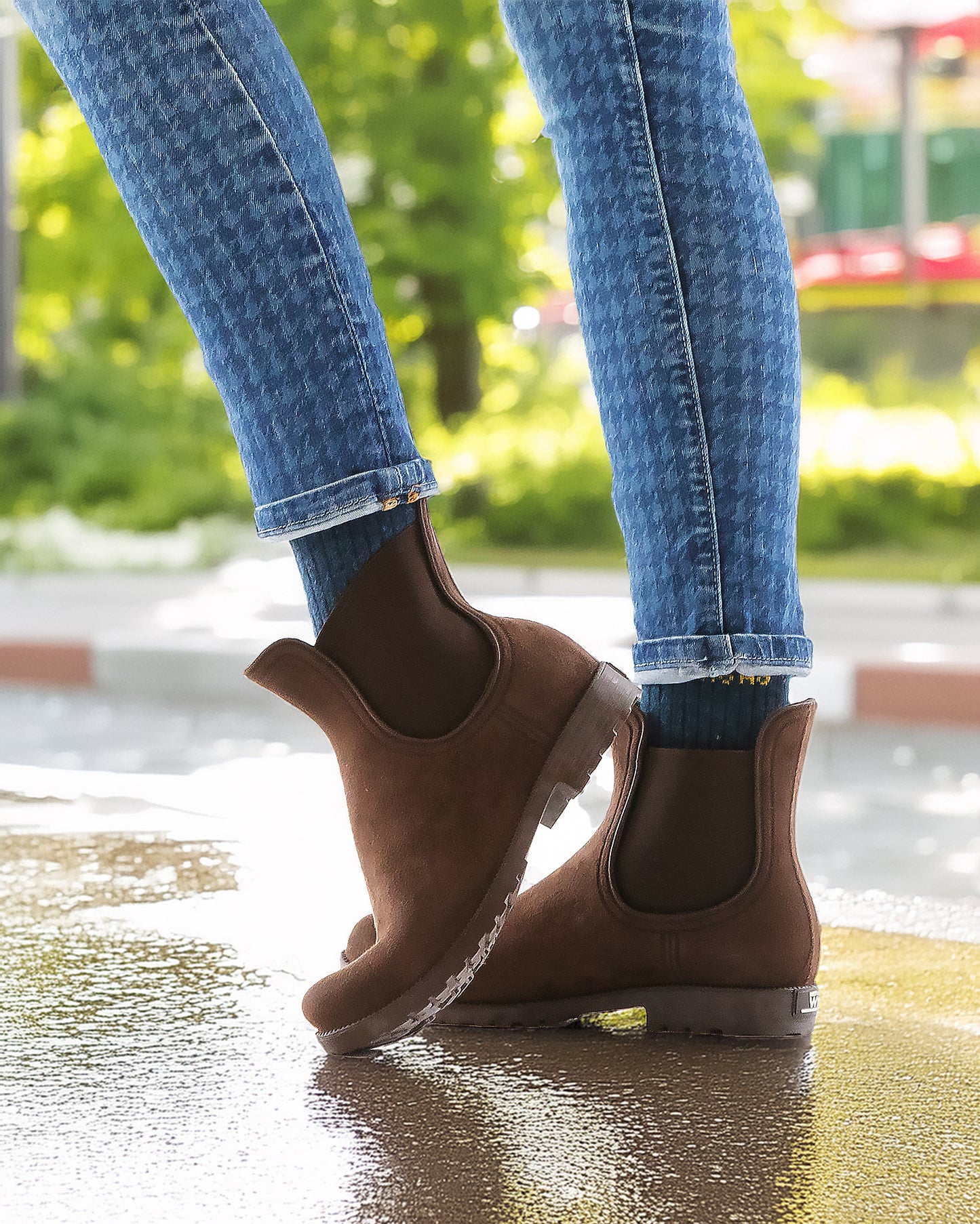 A pair of short rubber Chelsea boots for women, offering full waterproof protection, a modern low-profile fit, and superior traction for wet conditions.